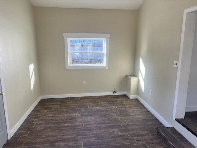 unfurnished room with dark hardwood / wood-style flooring