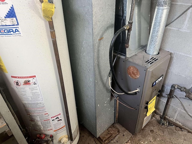 utility room with heating unit and gas water heater