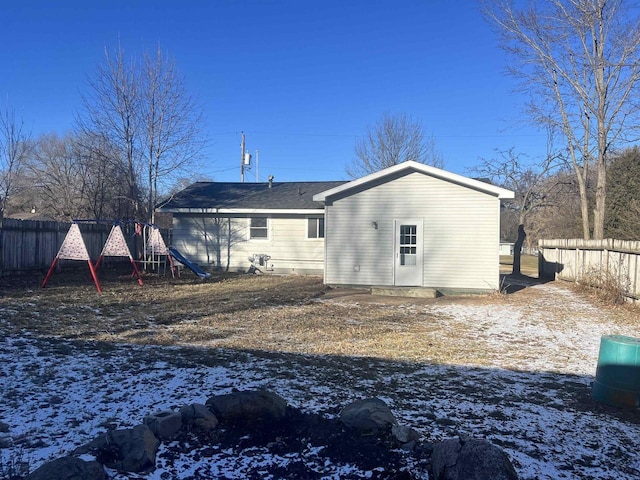 snow covered property featuring a playground