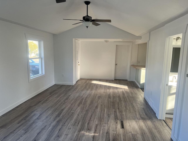 unfurnished living room with ceiling fan, lofted ceiling, and dark wood-type flooring