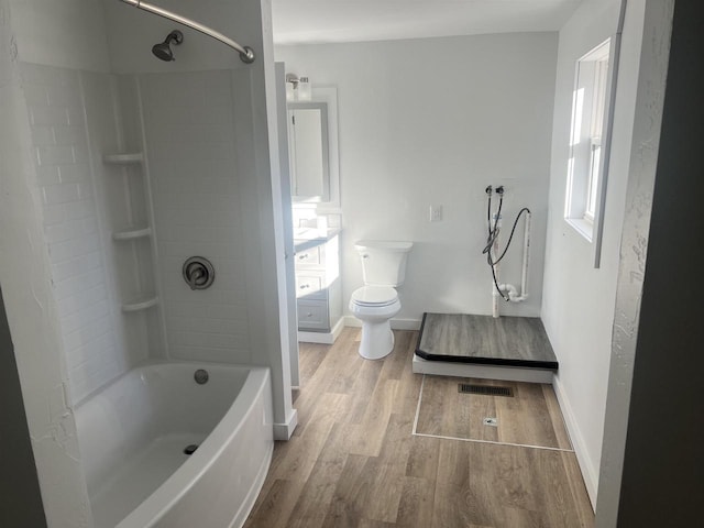 full bathroom with a wealth of natural light, hardwood / wood-style floors, tub / shower combination, and toilet