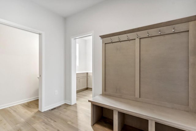 mudroom with light hardwood / wood-style flooring