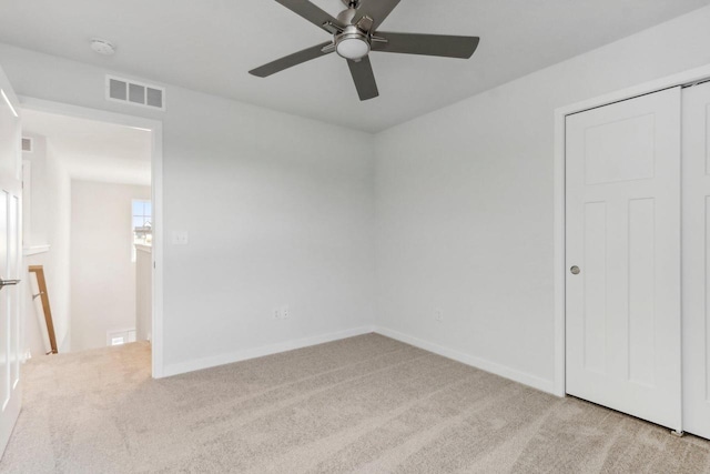 carpeted empty room with ceiling fan