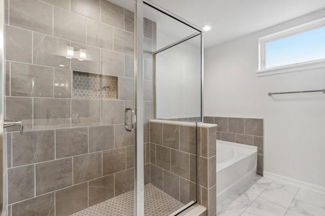 bathroom featuring separate shower and tub