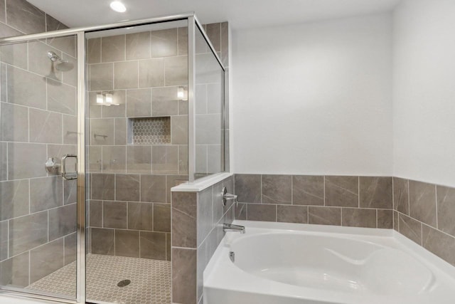 bathroom with separate shower and tub