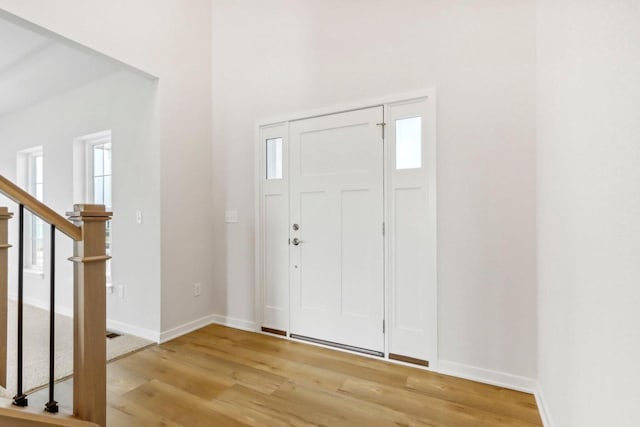 foyer entrance with light hardwood / wood-style floors