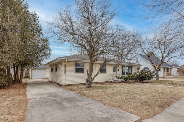 view of front of home with a garage, an outbuilding, and a front yard