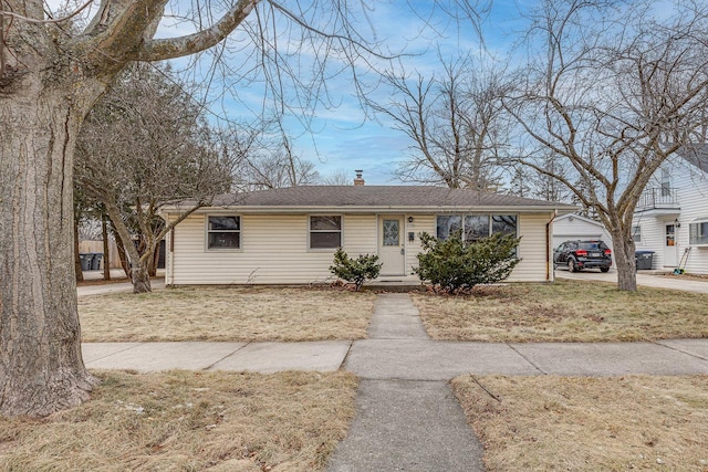 ranch-style house featuring a garage and a front yard