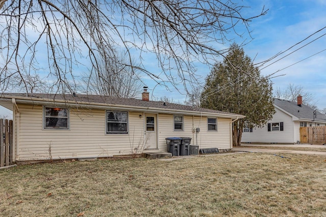 rear view of property with a yard