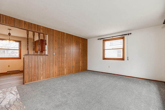 carpeted empty room with wooden walls