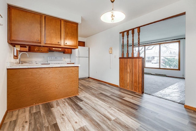 kitchen with white fridge, range, sink, and light hardwood / wood-style flooring