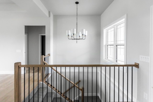 hall featuring a chandelier and hardwood / wood-style flooring