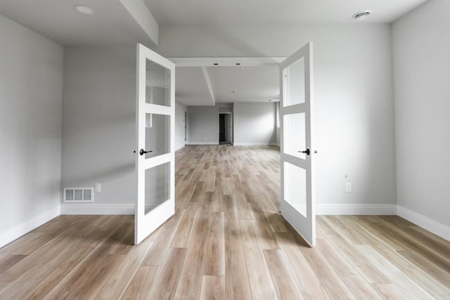 interior space featuring light wood-type flooring and french doors