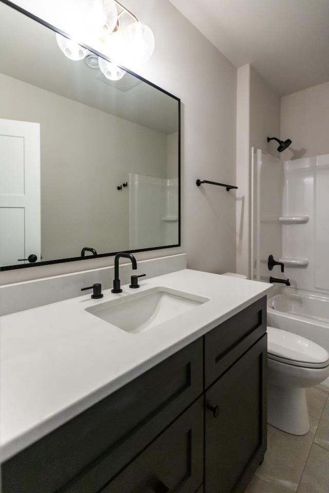 full bathroom featuring shower / bathing tub combination, tile patterned floors, vanity, and toilet