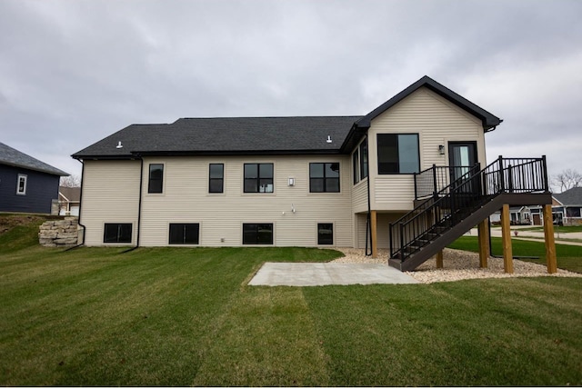 rear view of property with a lawn and a wooden deck