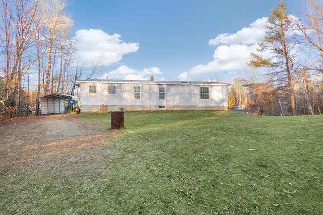 rear view of house with a carport and a lawn