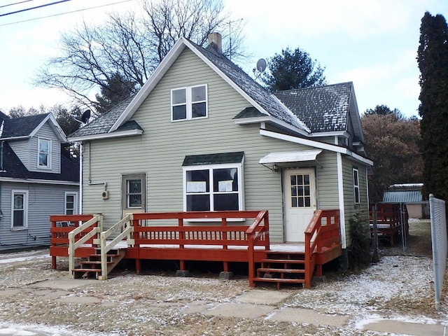 rear view of property featuring a deck