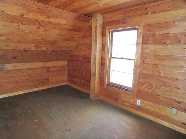 bonus room with dark wood-type flooring, wooden ceiling, vaulted ceiling, and wooden walls