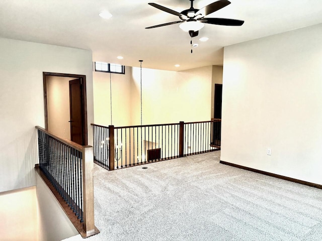 carpeted spare room with ceiling fan