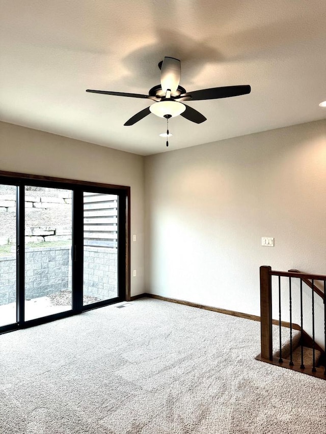 unfurnished room featuring ceiling fan and carpet floors