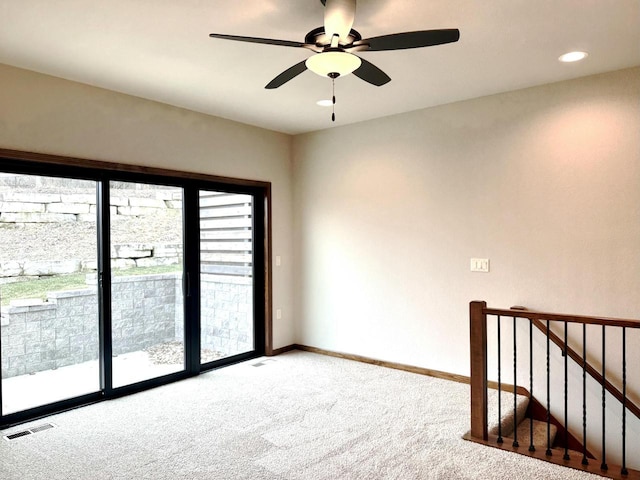 empty room featuring carpet flooring and ceiling fan