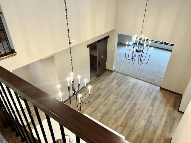 room details with hardwood / wood-style floors and a notable chandelier