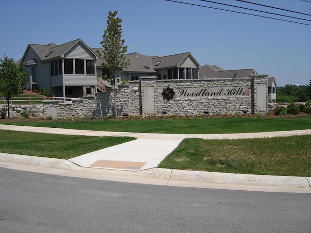 community / neighborhood sign featuring a yard