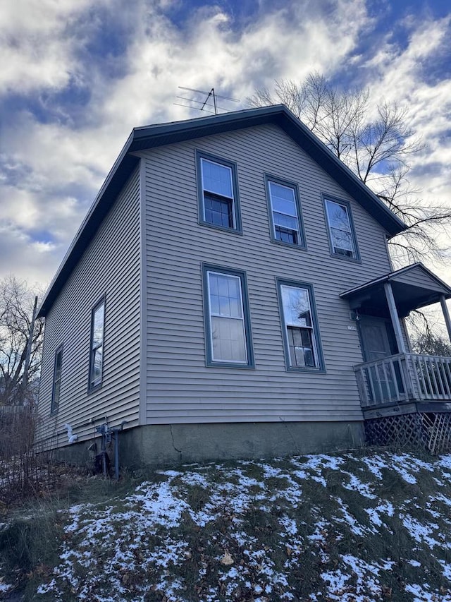 snow covered property featuring a porch