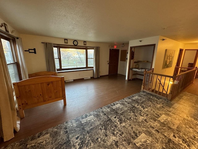 interior space featuring dark hardwood / wood-style floors and a textured ceiling