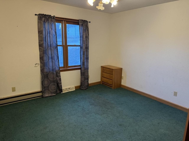 spare room featuring a baseboard heating unit and carpet floors