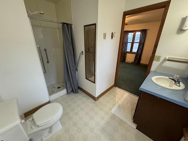 bathroom with vanity, toilet, and walk in shower