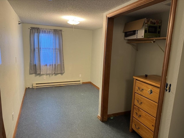 unfurnished bedroom featuring a textured ceiling and baseboard heating