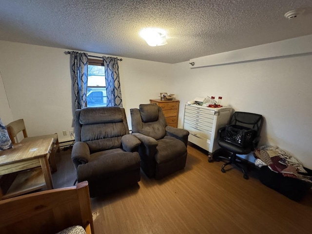 living area with hardwood / wood-style flooring and a textured ceiling