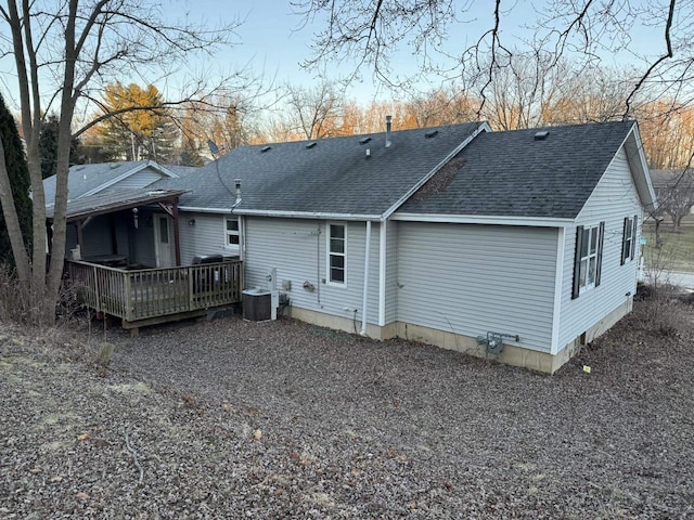 back of house with central AC and a deck