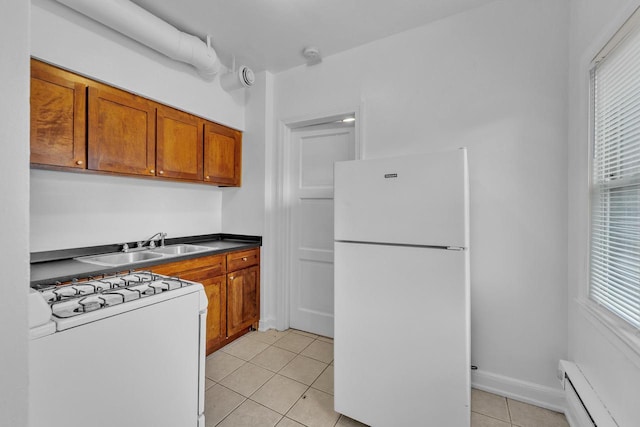 kitchen with light tile patterned flooring, white appliances, a baseboard heating unit, and sink