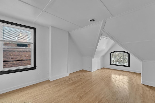 bonus room featuring light hardwood / wood-style flooring and vaulted ceiling