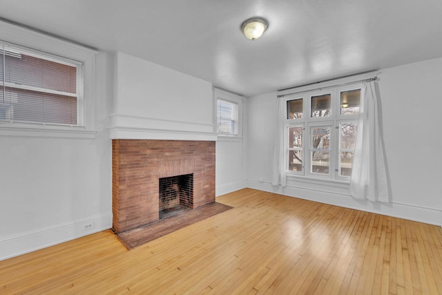 unfurnished living room featuring a fireplace and wood-type flooring