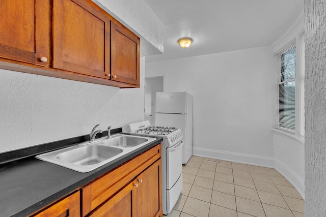 kitchen with light tile patterned floors, white appliances, crown molding, and sink