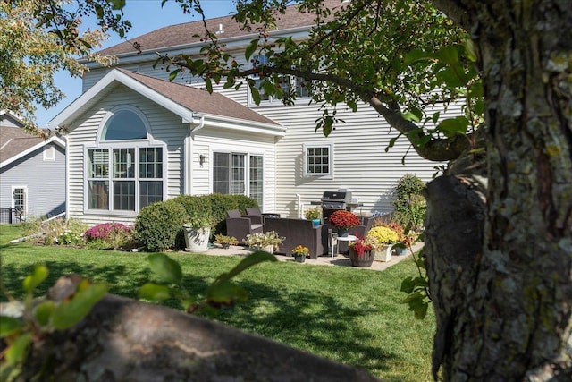 rear view of house featuring a patio, a lawn, and outdoor lounge area