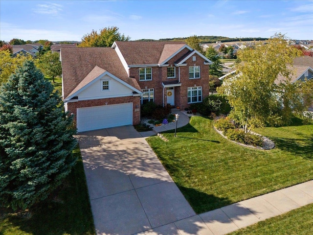 view of front property featuring a front lawn and a garage