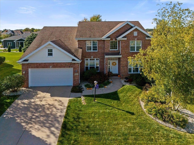 view of front of home with a front lawn and a garage