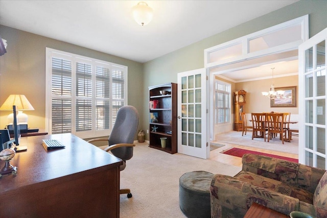 office area featuring a notable chandelier, light colored carpet, french doors, and ornamental molding