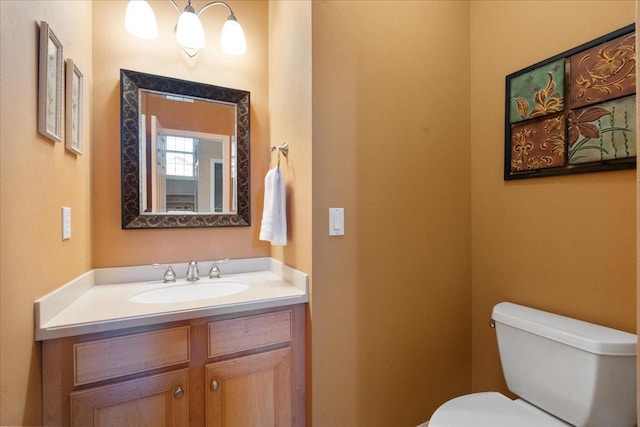 bathroom featuring toilet and vanity