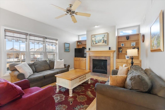 living room with a fireplace, hardwood / wood-style floors, and ceiling fan