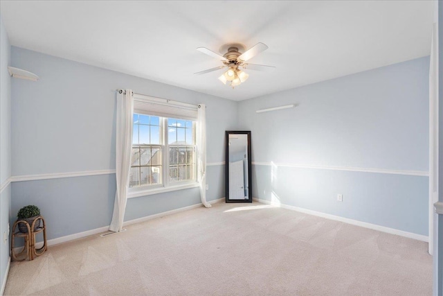 spare room featuring ceiling fan and light carpet