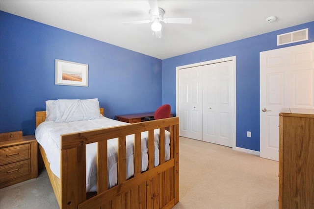 carpeted bedroom with a closet and ceiling fan