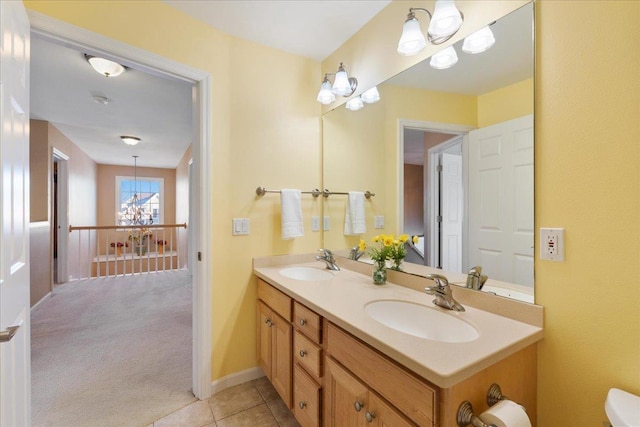 bathroom featuring vanity, tile patterned floors, and a chandelier