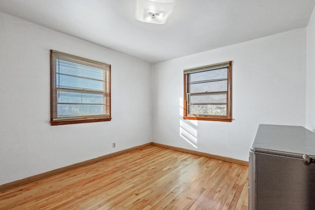 spare room with light hardwood / wood-style flooring