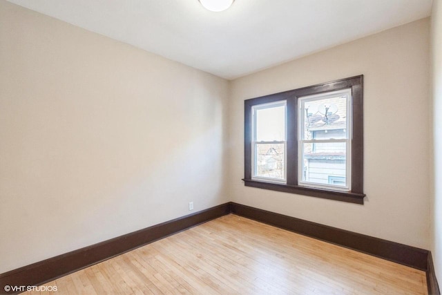 unfurnished room with hardwood / wood-style flooring