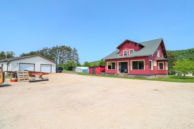 view of front of home with an outbuilding and a garage